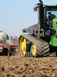 tractor spraying nitrogen stabilizer fertilizer on field